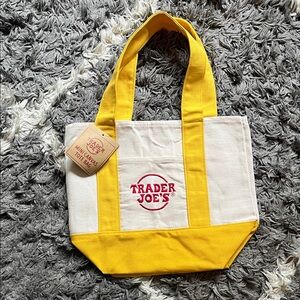 BRAND NEW ITEM. Trader Joe’s mini canvas tote bag. Yellow. New with tag.